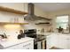 Well-lit kitchen featuring white countertops, floating shelves, and modern stainless steel appliances at 106 Eugene St, Carrboro, NC 27510