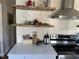 Well-organized kitchen countertop featuring floating shelves and modern appliances at 106 Eugene St, Carrboro, NC 27510