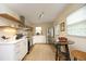 Modern kitchen featuring stainless steel appliances, white cabinets, and stylish open shelving at 106 Eugene St, Carrboro, NC 27510