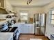 Bright kitchen featuring stainless steel appliances, floating shelves, and natural light at 106 Eugene St, Carrboro, NC 27510