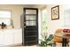 Bright kitchen featuring stainless steel appliances, white cabinetry, and a view of the outdoor scenery at 106 Eugene St, Carrboro, NC 27510