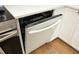 Samsung dishwasher with white paneling, seamlessly integrated into the kitchen cabinetry, and stainless steel hardware at 106 Eugene St, Carrboro, NC 27510