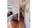 Open-concept living room with hardwood floors and cozy decor flows into hallway at 106 Eugene St, Carrboro, NC 27510