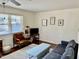 Cozy living room with hardwood floors, sofa, chair, and natural lighting at 106 Eugene St, Carrboro, NC 27510
