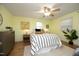 Cozy bedroom with hardwood floors, ceiling fan, and comfortable bedding, bathed in natural light at 106 Eugene St, Carrboro, NC 27510