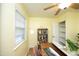 The home office has a ceiling fan, natural light, and features a practical desk and bookshelf at 106 Eugene St, Carrboro, NC 27510