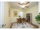 The home office has a ceiling fan, natural light, and features a practical desk and bookshelf at 106 Eugene St, Carrboro, NC 27510