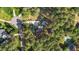 An aerial view of the property showcasing the house, pool, long driveway, and lush surroundings at 106 Wolverton Dr, Clayton, NC 27527