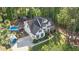 Aerial view of a two-story home with in-ground pool, deck, and well-maintained landscaping at 106 Wolverton Dr, Clayton, NC 27527
