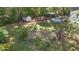 Aerial view of a large, fenced backyard with a pool, outbuildings, and mature trees at 106 Wolverton Dr, Clayton, NC 27527