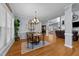 Open-concept dining room with hardwood floors and views into the living room and kitchen at 106 Wolverton Dr, Clayton, NC 27527