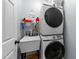 Convenient laundry room with stacked Samsung washer and dryer units and a utility sink for easy cleanup at 106 Wolverton Dr, Clayton, NC 27527