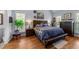 Spacious main bedroom with a plush bed, hardwood floors, and a cozy bench for relaxation at 106 Wolverton Dr, Clayton, NC 27527