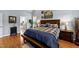 Inviting main bedroom featuring a comfortable bed, wood floors, and a view of the ensuite bath at 106 Wolverton Dr, Clayton, NC 27527