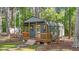 A backyard outbuilding with a porch, railing, and steps at 106 Wolverton Dr, Clayton, NC 27527