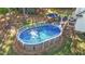 A backyard above ground pool with a deck, patio, and lounge chairs at 106 Wolverton Dr, Clayton, NC 27527