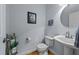 Charming powder room with a pedestal sink, toilet, and decor accents creating a cozy space at 106 Wolverton Dr, Clayton, NC 27527