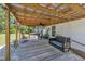 Covered back porch featuring wood decking and an outdoor porch swing at 1112 Turner Farms Rd, Garner, NC 27529