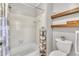 Classic bathroom with neutral paint features shower-tub combo, floating wood shelves, and ornate toilet paper holder at 1112 Turner Farms Rd, Garner, NC 27529