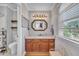Charming bathroom features stylish vanity, granite counters, and ornate mirror with shelf and neutral paint at 1112 Turner Farms Rd, Garner, NC 27529