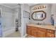 Charming bathroom features stylish vanity, granite counters, ornate mirror and shower-tub combo with neutral paint at 1112 Turner Farms Rd, Garner, NC 27529