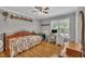 Cozy bedroom featuring hardwood floors, window, ceiling fan, and traditional accents at 1112 Turner Farms Rd, Garner, NC 27529