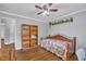 Bedroom with hardwood floors, daybed, ceiling fan, and built-in bookshelf at 1112 Turner Farms Rd, Garner, NC 27529