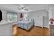 Bright bedroom with wood floors and ceiling fan features neutral paint, a window and matching furnishings at 1112 Turner Farms Rd, Garner, NC 27529