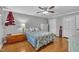 Bright bedroom with wood floors and ceiling fan features neutral paint, a window and matching furnishings at 1112 Turner Farms Rd, Garner, NC 27529