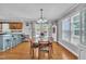 A bright dining area with a wood table, chandelier, and access to the kitchen at 1112 Turner Farms Rd, Garner, NC 27529