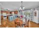 An inviting dining area with a wood table, chandelier, and access to the patio at 1112 Turner Farms Rd, Garner, NC 27529