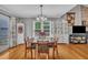 Formal dining room filled with natural light features wood floors, bright neutral paint and detailed china cabinet at 1112 Turner Farms Rd, Garner, NC 27529