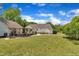 Exterior view of the home showcasing a manicured lawn, mature trees, and a covered porch at 1112 Turner Farms Rd, Garner, NC 27529