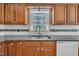 Close up of the kitchen sink with wooden cabinets and marble backsplash at 1112 Turner Farms Rd, Garner, NC 27529