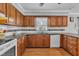 A lovely kitchen with wooden cabinets, white appliances, and gray countertops at 1112 Turner Farms Rd, Garner, NC 27529