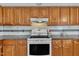 The kitchen features wooden cabinets, white appliances, and a gray countertop at 1112 Turner Farms Rd, Garner, NC 27529