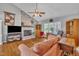 Cozy living room with a brick fireplace, hardwood floors, and comfortable seating arrangements at 1112 Turner Farms Rd, Garner, NC 27529