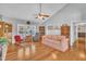 A bright and spacious living room with hardwood floors, a ceiling fan, and comfortable seating at 1112 Turner Farms Rd, Garner, NC 27529