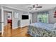 Bright main bedroom with wood floors features ceiling fan, matching furnishings, and large window at 1112 Turner Farms Rd, Garner, NC 27529