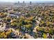 Aerial view showcasing neighborhood, city skyline, mature trees, and well-maintained houses at 117 Idlewild Ave, Raleigh, NC 27601