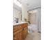 Bathroom with a wood vanity, cream walls, a bathtub with tile surround and a shower curtain at 117 Idlewild Ave, Raleigh, NC 27601