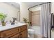 Bathroom with a wood vanity, cream walls, a bathtub with tile surround and a shower curtain at 117 Idlewild Ave, Raleigh, NC 27601