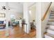 A charming home entryway with a view of the powder room and staircase at 117 Idlewild Ave, Raleigh, NC 27601