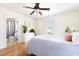 Bedroom featuring an en suite bathroom, white dresser, a ceiling fan, and a queen-size bed at 117 Idlewild Ave, Raleigh, NC 27601