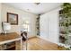 Bright bedroom features a Murphy bed, built-in shelves with plant decor, and a wood desk by the window at 117 Idlewild Ave, Raleigh, NC 27601