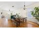 Open concept dining area with a large wooden table, bench seating, and plenty of natural light at 117 Idlewild Ave, Raleigh, NC 27601