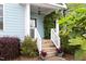 Inviting front porch with lush greenery and a decorative front door at 117 Idlewild Ave, Raleigh, NC 27601