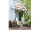 Inviting front porch with lush greenery and a decorative front door at 117 Idlewild Ave, Raleigh, NC 27601