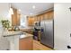 Updated kitchen featuring stainless steel appliances, wood cabinetry, and granite countertops at 117 Idlewild Ave, Raleigh, NC 27601