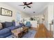 Bright living room with hardwood floors, a ceiling fan, stylish furniture, and an open floor plan at 117 Idlewild Ave, Raleigh, NC 27601